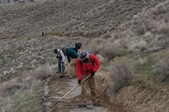 Raking gravel onto Canyon Trail