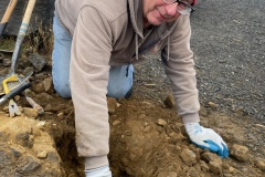 Jim Langdon digging posthole for sign on Candy