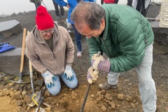 Jim Langdon and Floyd Stredwick digging posthole for sign on Candy