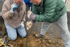 Jim Langdon and Floyd Stredwick digging posthole for sign on Candy