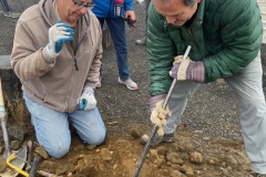 Jim Langdon and Floyd Stredwick digging posthole for sign on Candy